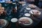 Glasses, forks, knives, plates on a table in restaurant served for dinner.