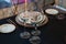 Glasses, forks, knives, plates on a table in restaurant served for dinner.