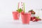 Glasses of fresh cold smoothie with fruit and berries, on white table background.