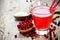 Glasses of fresh cranberry drink on wooden background. Red bilberry, whortleberry, huckleberry, cowberry, foxberry, lingberry, li