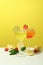 Glasses of fresh summer cocktails against yellow background