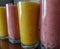 Glasses of healthy colorful nutritious fruit smoothies protein shake drinks placed on the table