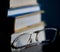 Glasses lie on a stack of books, science