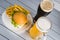 Glasses of light and dark beer with cheeseburger and French fries on aluminum panels