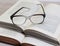 Glasses and open books on the table