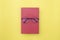 Glasses placed on red book, On yellow background