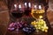 Glasses of red, rose and white wine with cheese, and grape in wine cellar