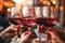 Glasses with red wine in hands of people, ready to toast and cheers with friends. Closeup moment of connection and enjoyment