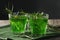 Glasses of refreshing tarragon drink on table, closeup