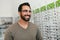 Glasses Shop. Man Trying On Eyeglasses In Optics Store