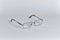 Glasses in a silver frame are located diagonally, close-up, isolated on