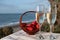 Glasses of Spanish cava sparkling wine with fresh ripe strawberry and view on blue sea and sandy beach, Costa del Sol vacation