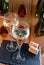 Glasses of sparkling white wine champagne or cava with bubbles and classic wooden champagne pupitre rack with empty bottles on