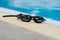 Glasses for swimming black on pool edge