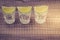 Glasses of tequila with a lime/glasses of tequila with a lime stand in a row. Copy space. Top view