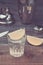 Glasses of tequila with a lime/preparation of shot with a lime in a shaker on a wooden background. Toned