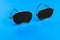 Glasses trainers. Black pinhole glasses on blue background. Medical concept. Top view