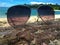 Glasses on a tree trunk on a beach