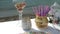 Glasses and vases on table by sand seashore.