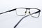 Glasses for the visually impaired, poorly sighted.glasses with aspherical astigmatic lenses  in black frame on a white background.