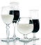 Glasses with white and black drinks on a glass surface
