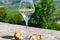 Glasses of white wine from vineyards of Sancerre Chavignol appelation and example of flint pebbles soil, near Sancerre village,