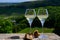 Glasses white wine from vineyards of Sancerre Chavignol appelation and example of flint pebbles soil, near Sancerre village, Cher