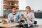 With glasses of wine. Couple preparing food at home on the modern kitchen