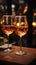 Glasses of wine poised for a romantic dining experience in a cozy restaurant