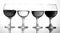 Glasses with wine on white background. A row of half-empty wine groceries. Four glasses with a variety of drinks