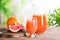 Glassware with citrus juice and grapefruit on table