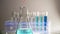 Glassware containing chemical liquid for research or analyzing a sample into test tube in laboratory.