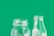 Glassware crystal bottle jar on green background. Reusable materials plastic-free alternatives zero waste environmental protection