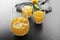 Glassware of fresh lemon juice on dark table