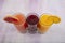 Glassware with refreshing citrus fruits cocktail on white wooden background. Antioxidant juices of Pomegranate Juice, Orange Juice