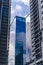 A glassy office building in center framed by two other highrises. Business, economy or financial concept. Shot in Fort Bonifacio.