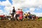 Glastonbury Festival crowds walk through mud beneath sunny sky