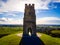 Glastonbury Tor near Glastonbury in the English county of Somerset, topped by the roofless St Michael`s Tower