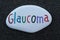 Glaucoma disease word carved and painted on a stone