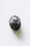 Glaucophane polished tumbled stone pebble on a white background with empty space