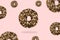 Glazed brown sweet sugar chocolate doughnut donut dessert on pink pastel background. Creative minimal blurred selective