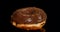 Glazed chocolate donut on black background