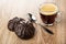 Glazed chocolate marshmallows, spoon, coffee in transparent cup on table