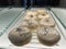 Glazed donuts with tiramisu inside a shop counter