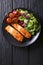 Glazed salmon fillet and fresh vegetable salad close-up on the t