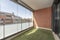 Glazed terrace with brick wall with artificial grass floor