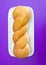 Glazed twist donut on rectangle plate on purple background