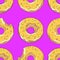 Glazed yellow donuts on purple background