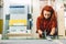 Glazier woman worker cutting glass in workshop.