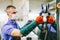 Glazier worker in face mask holding glass in workshop